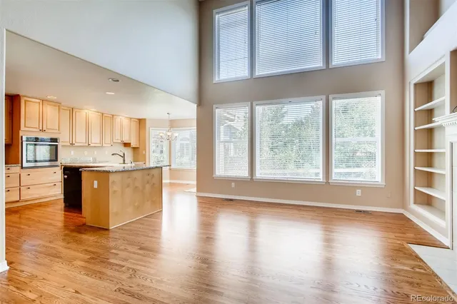 a view of kitchen with granite countertop window and wooden floor