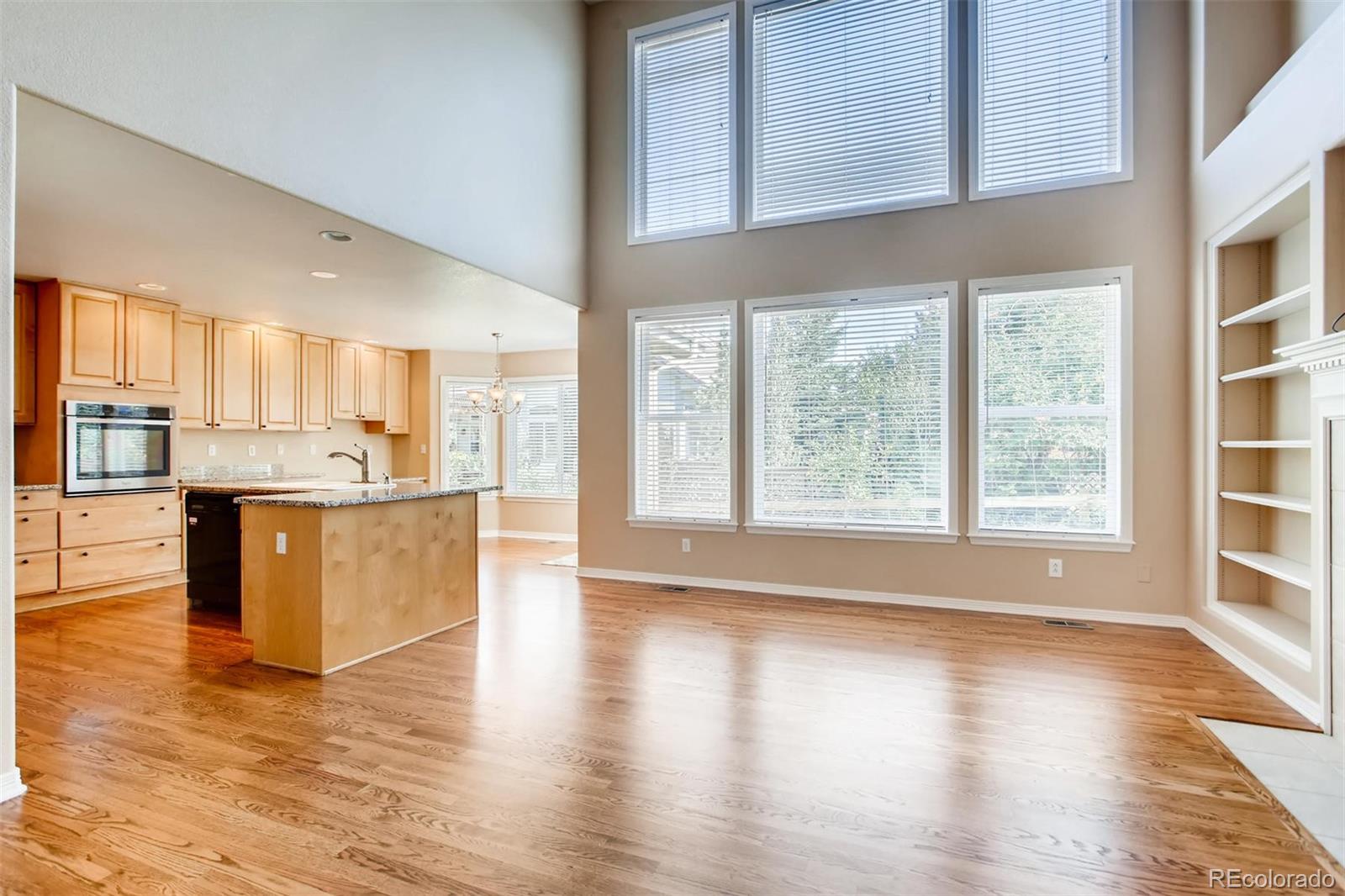 9535 East Aspen Hill Place Lone Tree, CO 80124 - Photo 15 of 28 a view of kitchen with granite countertop window and wooden floor