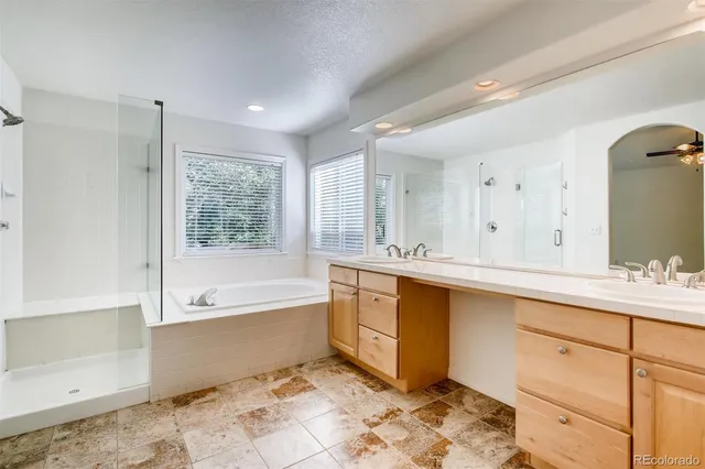 a spacious bathroom with a double vanity sink and a mirror