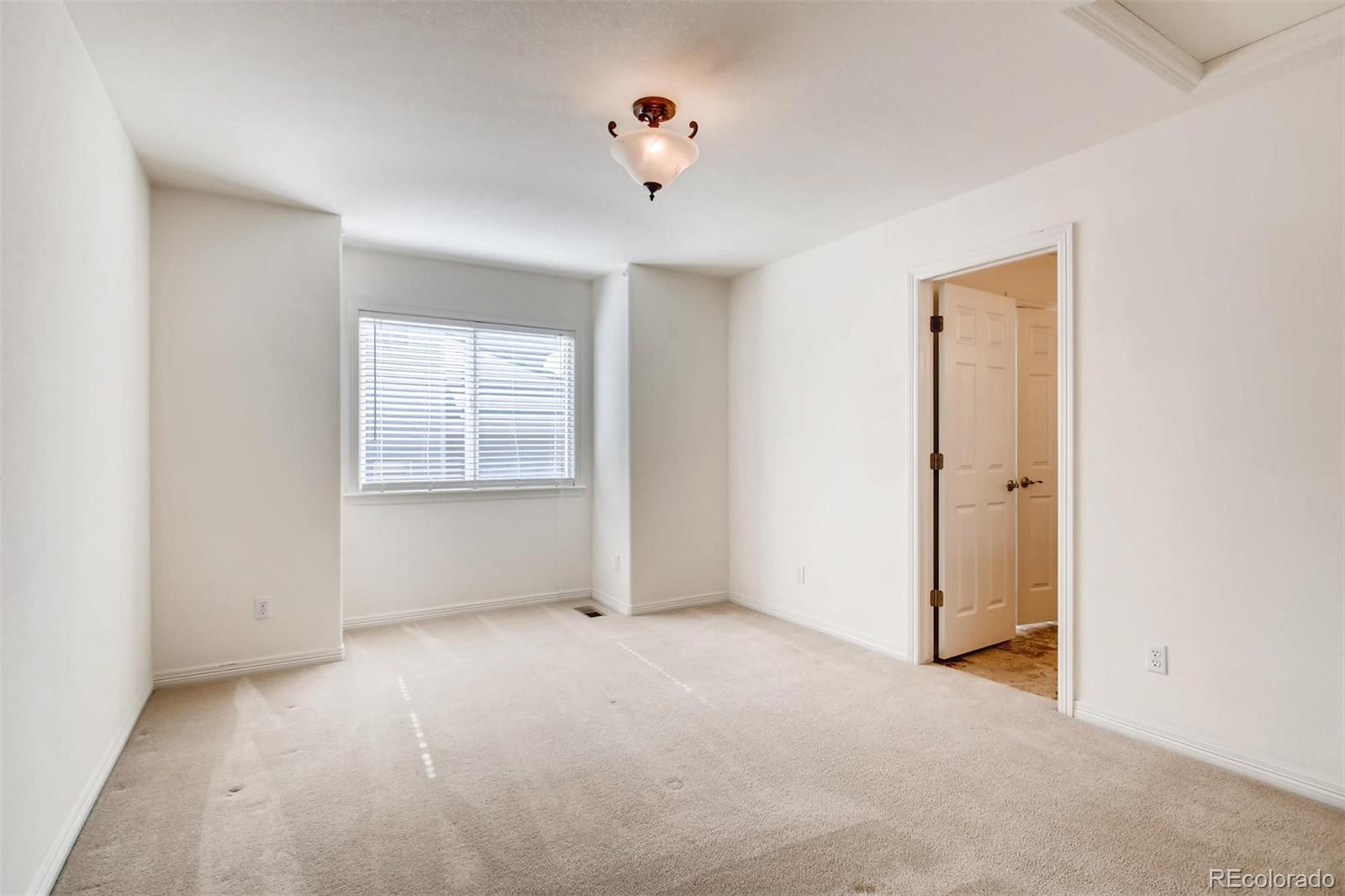 9535 East Aspen Hill Place Lone Tree, CO 80124 - Photo 22 of 28 an empty room with windows and closet