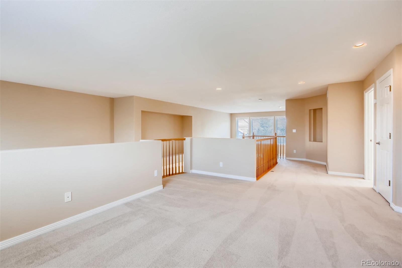 9535 East Aspen Hill Place Lone Tree, CO 80124 - Photo 24 of 28 a view of a big room with wooden cabinet and refrigerator