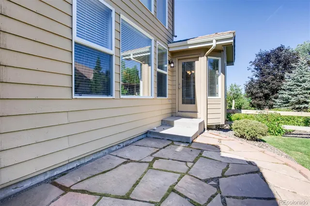 a view of a house with backyard and sitting area