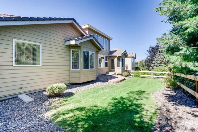 a view of a house with a yard and sitting area