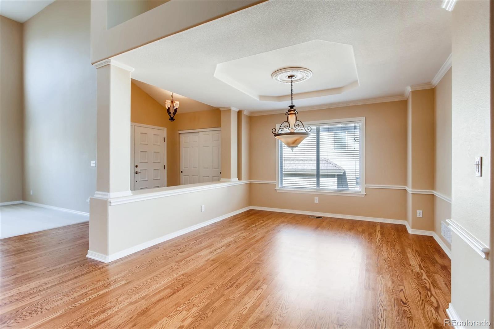 9535 East Aspen Hill Place Lone Tree, CO 80124 - Photo 7 of 28 a view of an empty room with wooden floor and a window