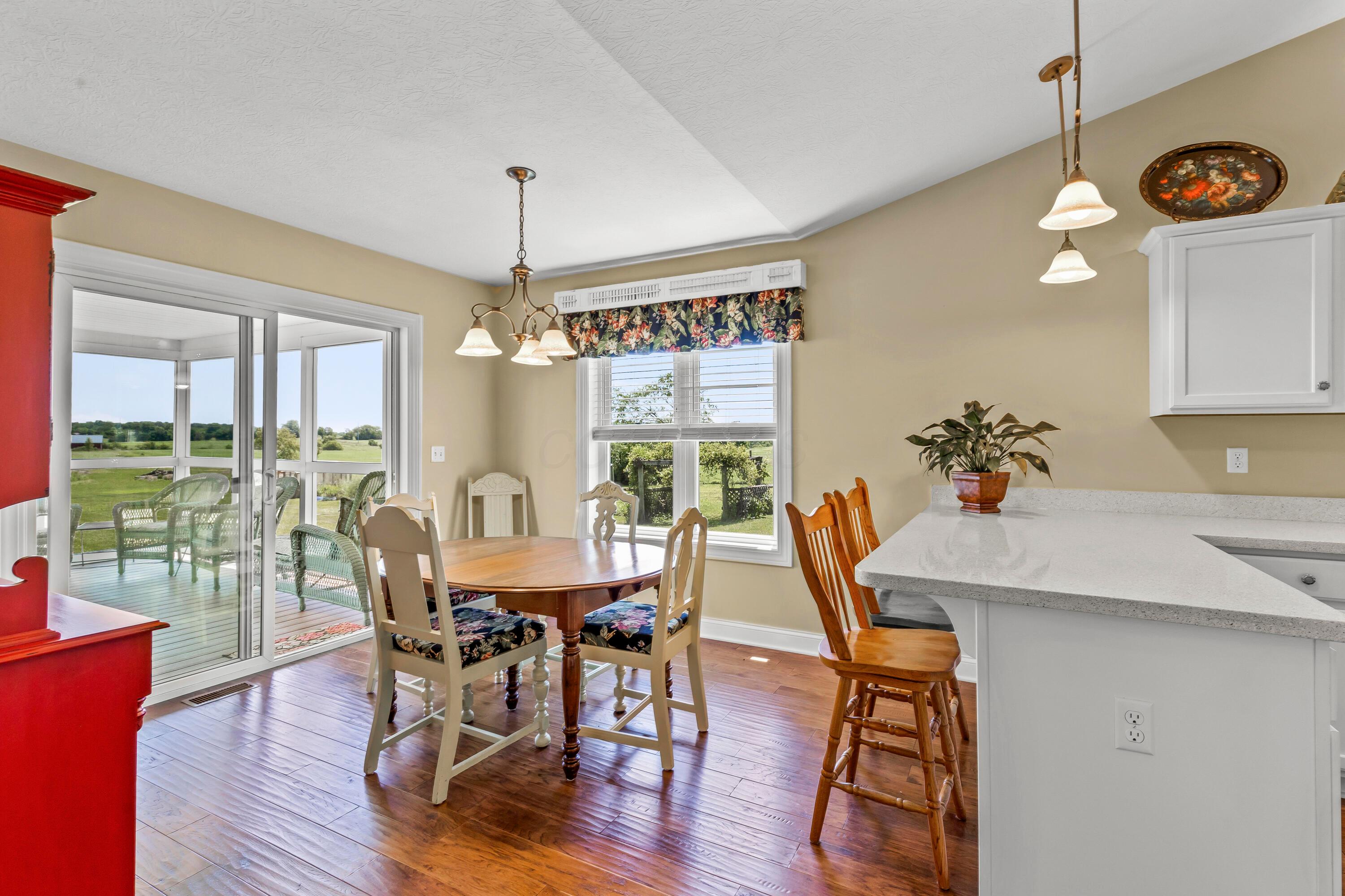 3582 Panhandle Road Delaware, OH 43015 - Photo 29 of 65 • New englewood flooring ~ 2015 • Ivory painted walls • Chandelier • 2” blinds • Sliding doors to screened porch