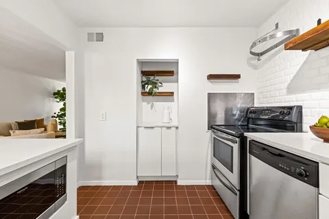 a kitchen with a sink cabinets and stainless steel appliances
