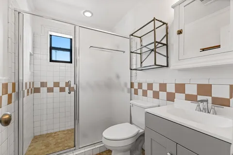 a bathroom with a sink toilet and shower