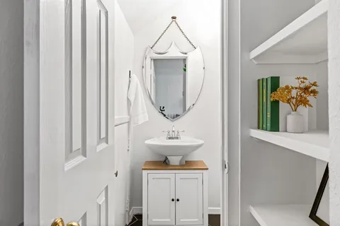 a bathroom with a sink a mirror and a toilet