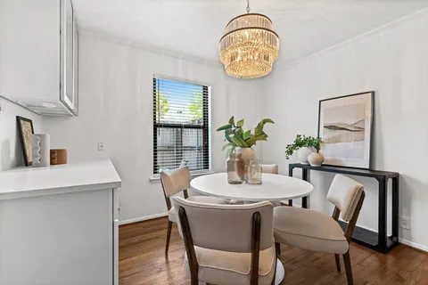 a dining room with furniture and window