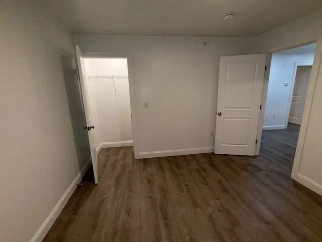 a view of hallway with wooden floor