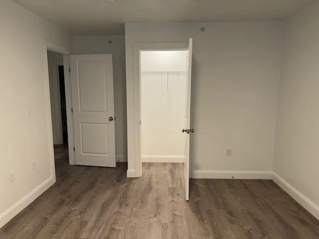 an empty room with wooden floor