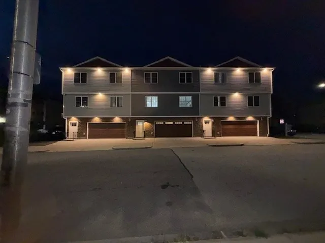 a front view of a house with a street