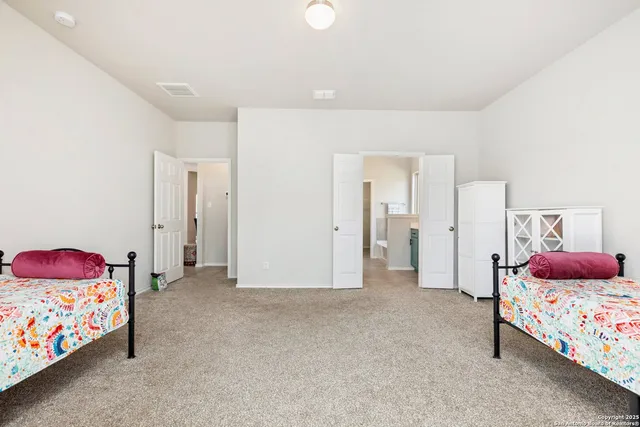 a spacious bedroom with a bed and a couch