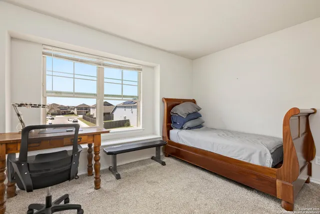 a bedroom with a bed and a window