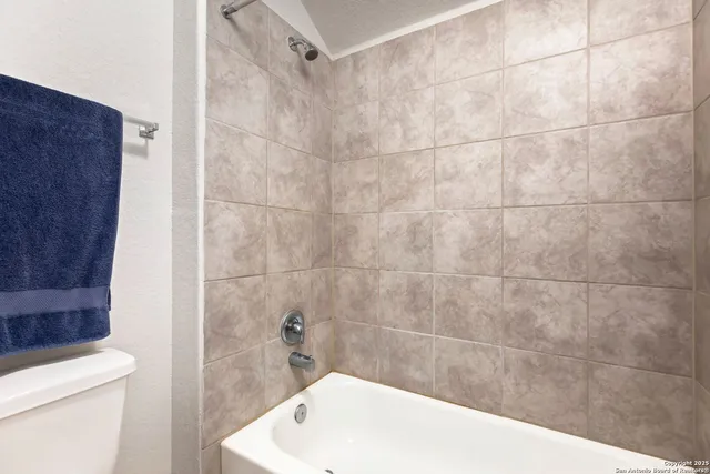 a bath tub sitting next to a white toilet