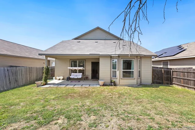 a front view of a house with a yard glass top table and chairs