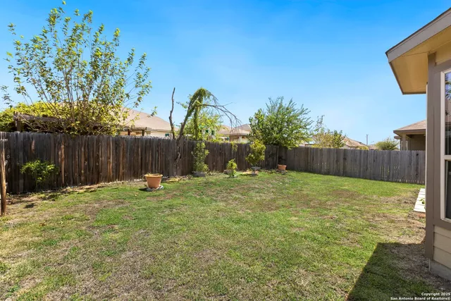 a backyard of a house with table and chairs
