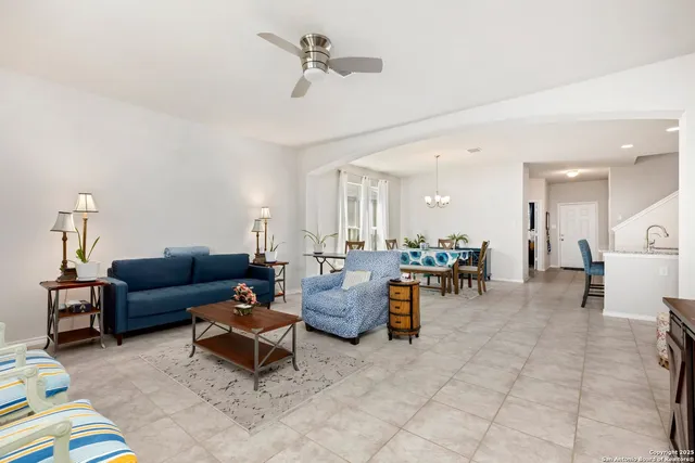 a living room with furniture and a chandelier