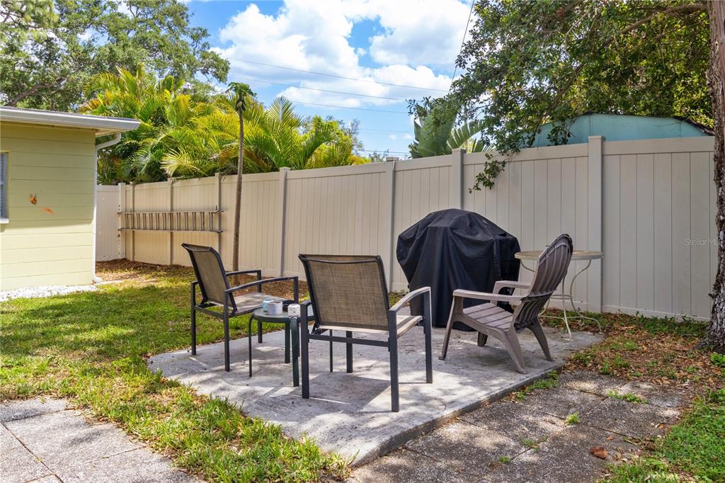 5596 100th Way North St. Petersburg, FL 33708 - Photo 34 of 67 a view of a chairs and table in backyard