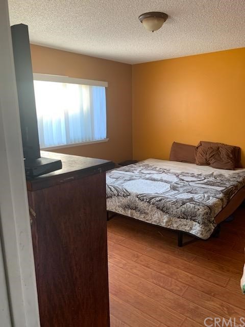 24510 Pace Drive Moreno Valley, CA 92557 - Photo 3 of 13 a bedroom with a bed and wooden floor