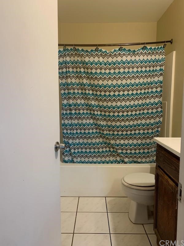 24510 Pace Drive Moreno Valley, CA 92557 - Photo 5 of 13 a bathroom with a toilet and a shower curtain