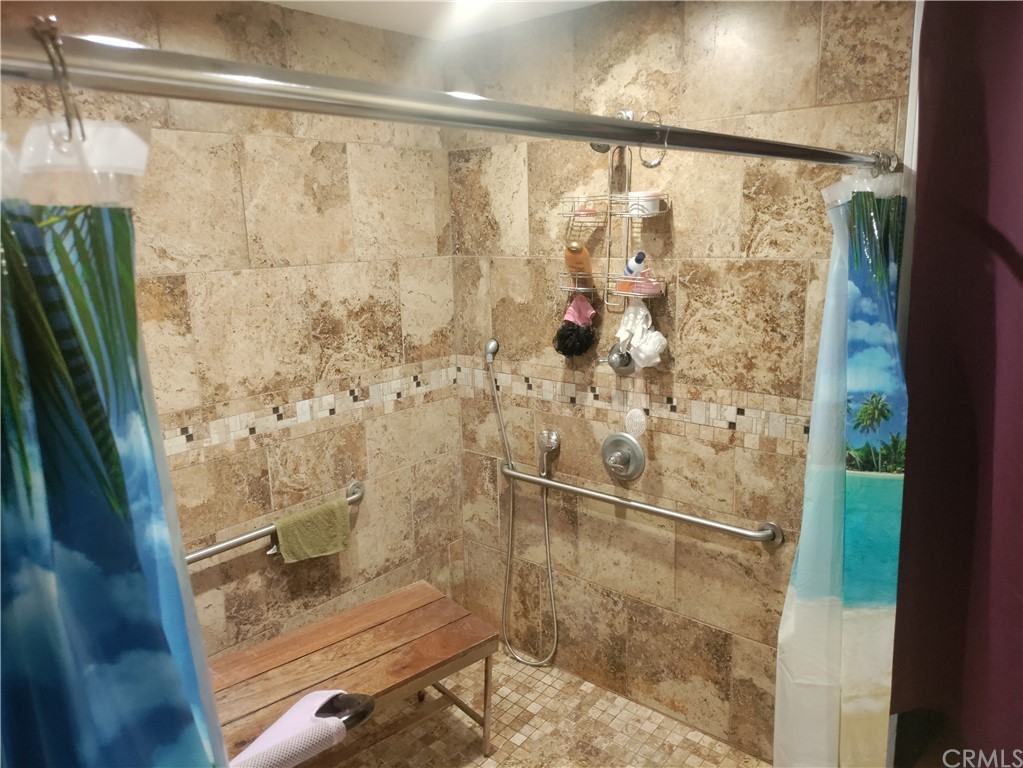 24510 Pace Drive Moreno Valley, CA 92557 - Photo 9 of 13 a bathroom with a glass shower door