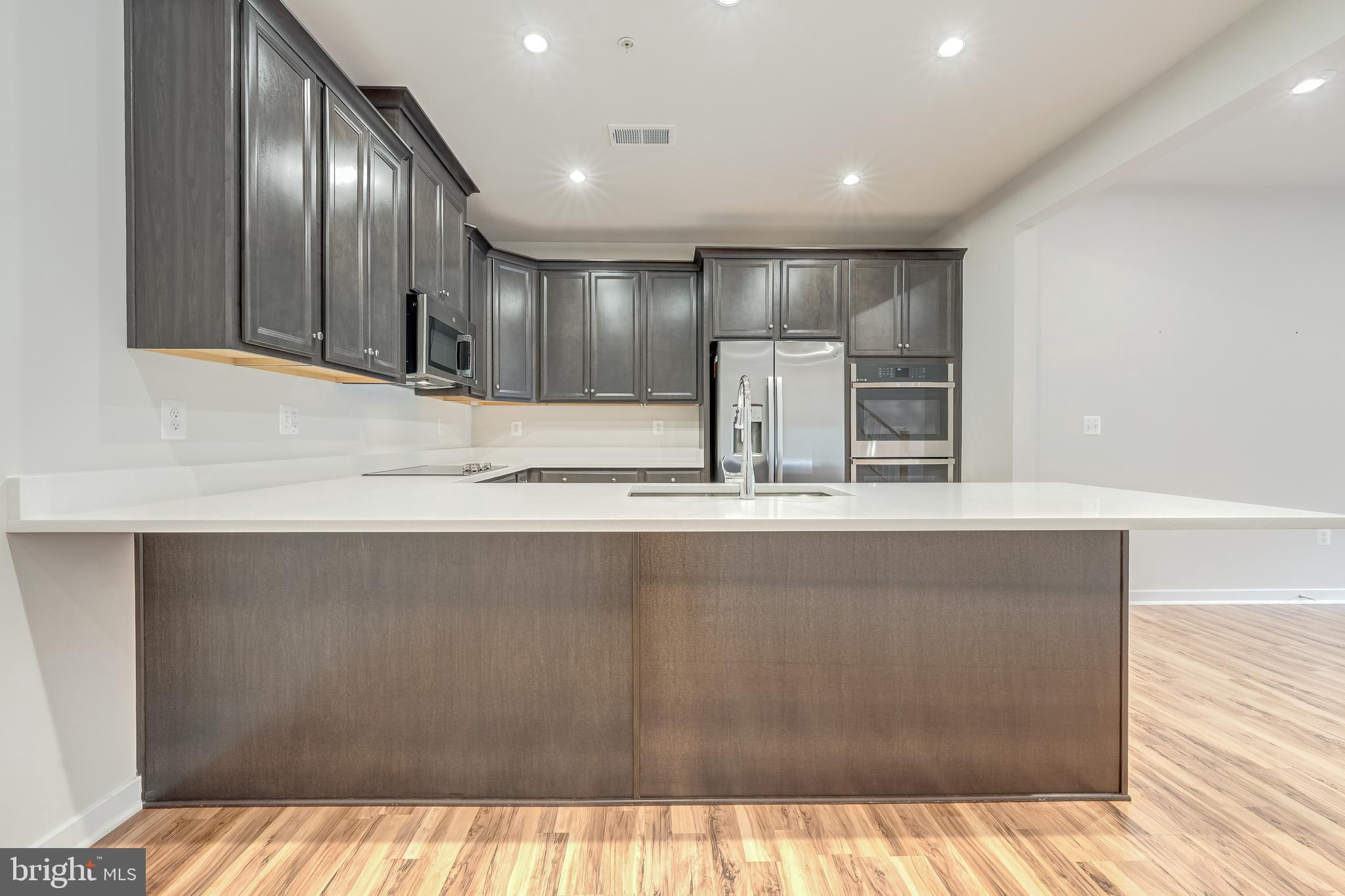 13504 Innovation Station Loop, Unit 2A Herndon, VA 20171 - Photo 15 of 36 a view of a kitchen with a sink