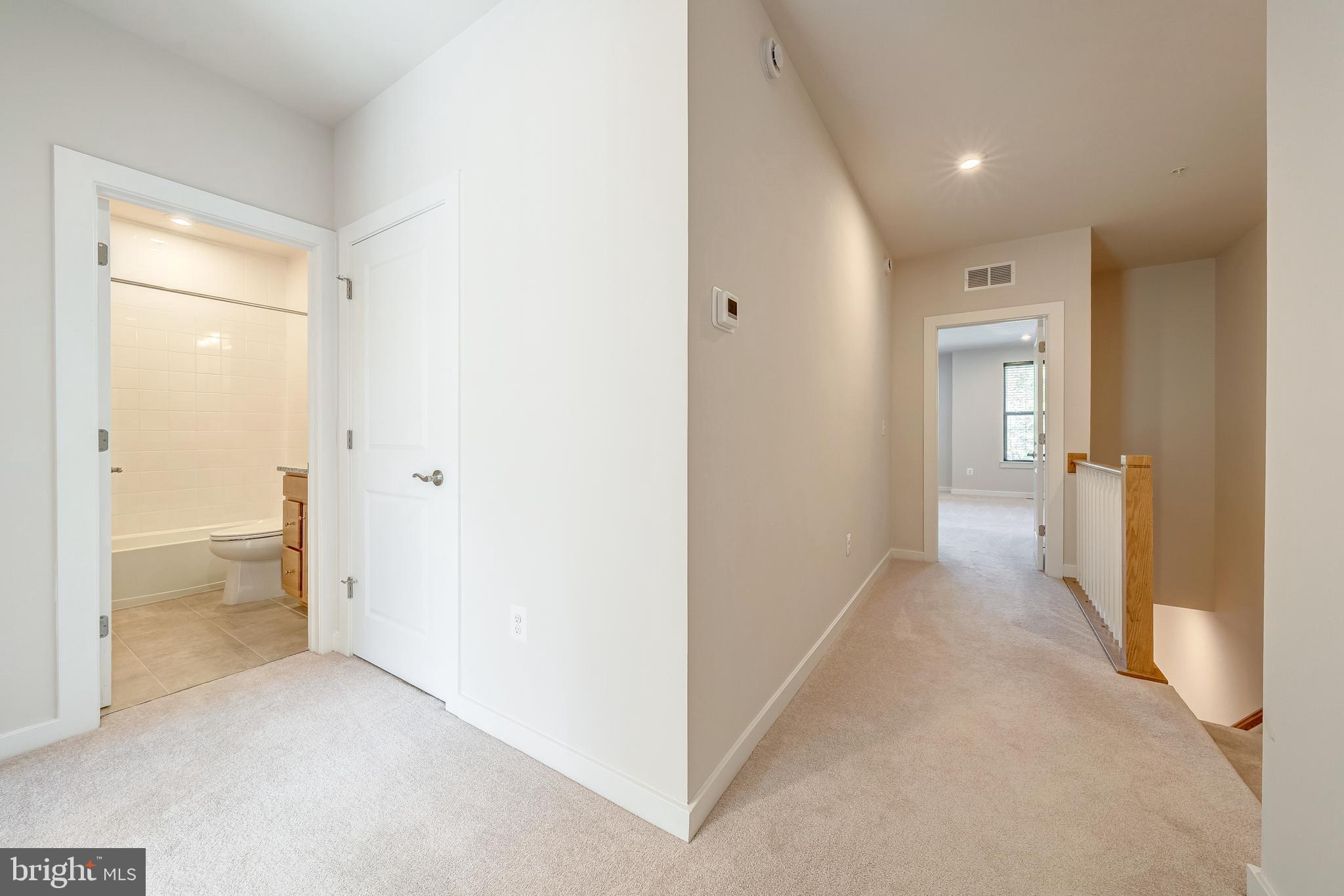 13504 Innovation Station Loop, Unit 2A Herndon, VA 20171 - Photo 22 of 36 a view of a hallway with wooden floor