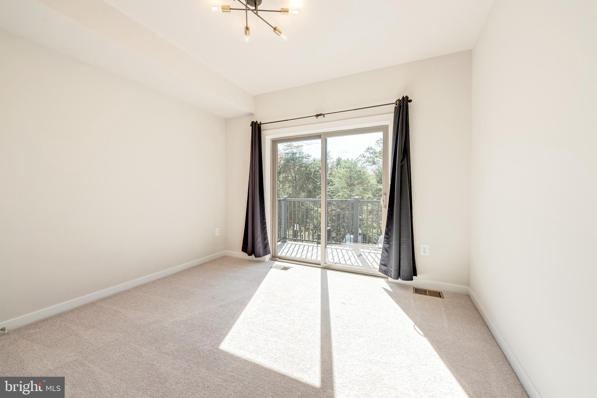 13504 Innovation Station Loop, Unit 2A Herndon, VA 20171 - Photo 31 of 36 a view of an empty room with a window