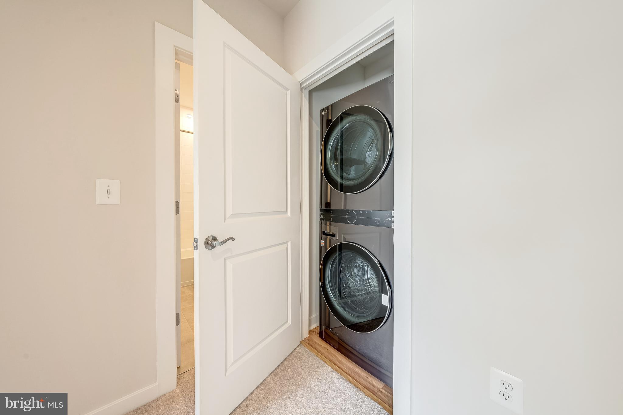 13504 Innovation Station Loop, Unit 2A Herndon, VA 20171 - Photo 34 of 36 a view of a hallway with washer and dryer