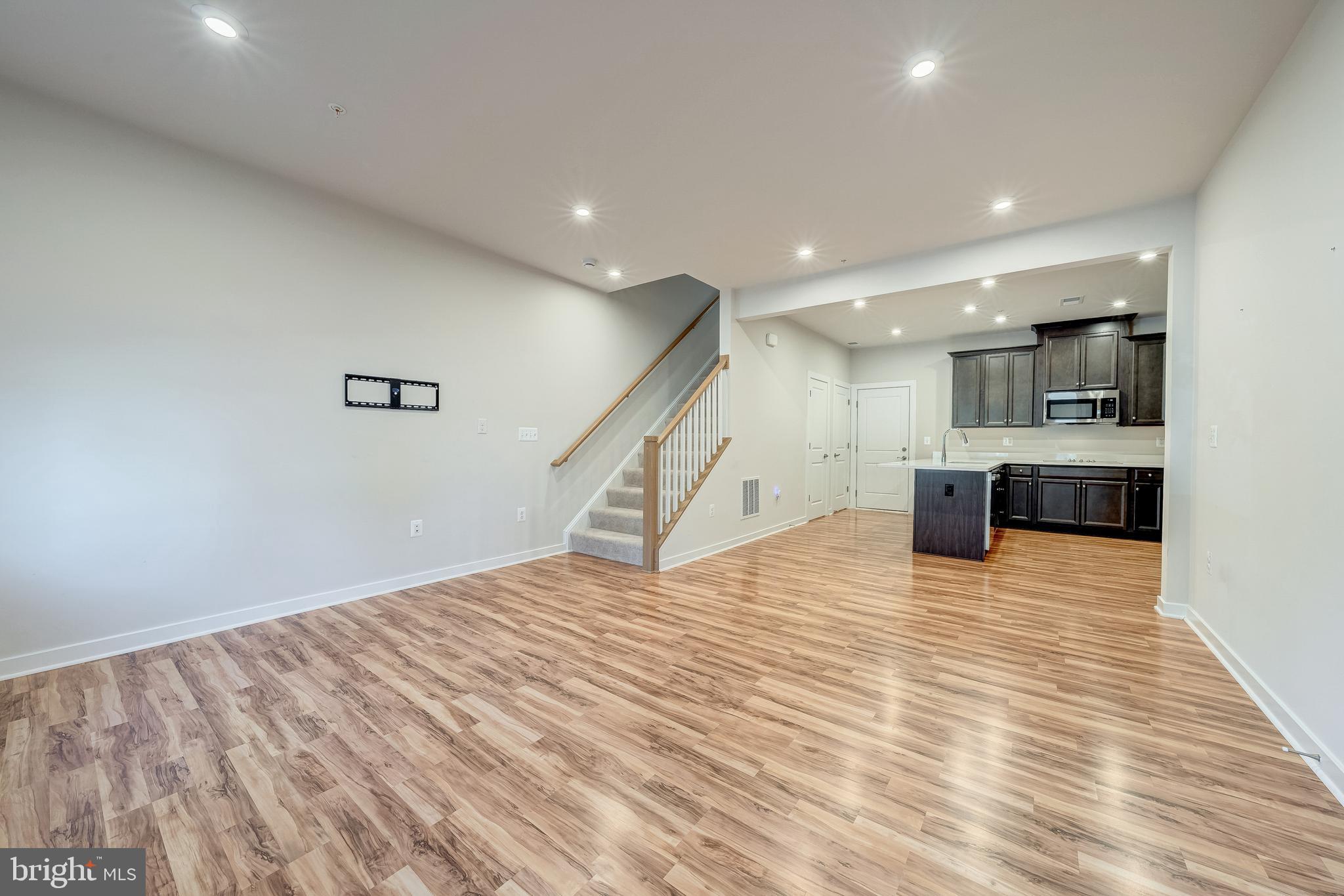 13504 Innovation Station Loop, Unit 2A Herndon, VA 20171 - Photo 7 of 36 a view of a kitchen with kitchen island wooden floor center island and stainless steel appliances