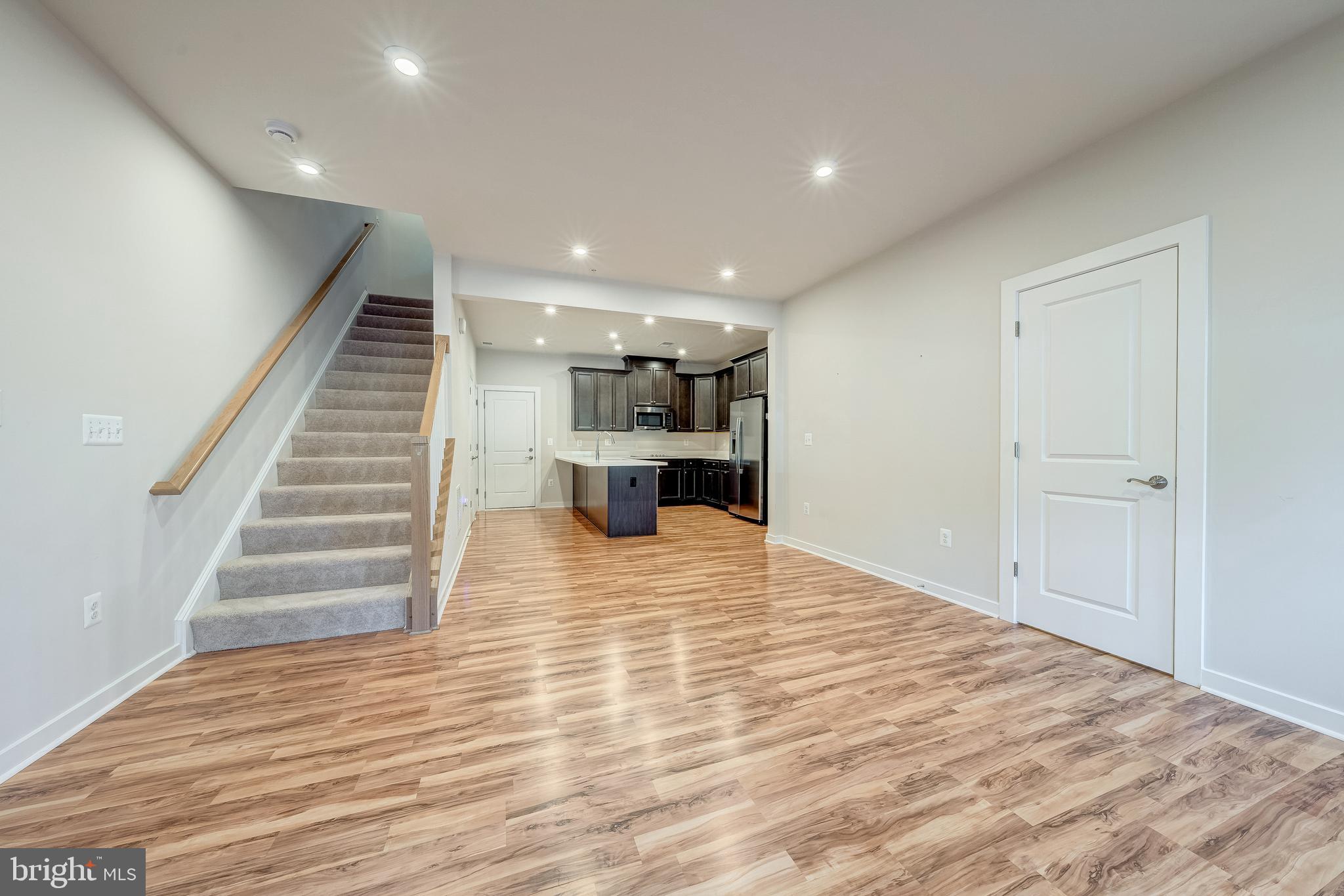 13504 Innovation Station Loop, Unit 2A Herndon, VA 20171 - Photo 8 of 36 a view of kitchen and empty room with wooden floor
