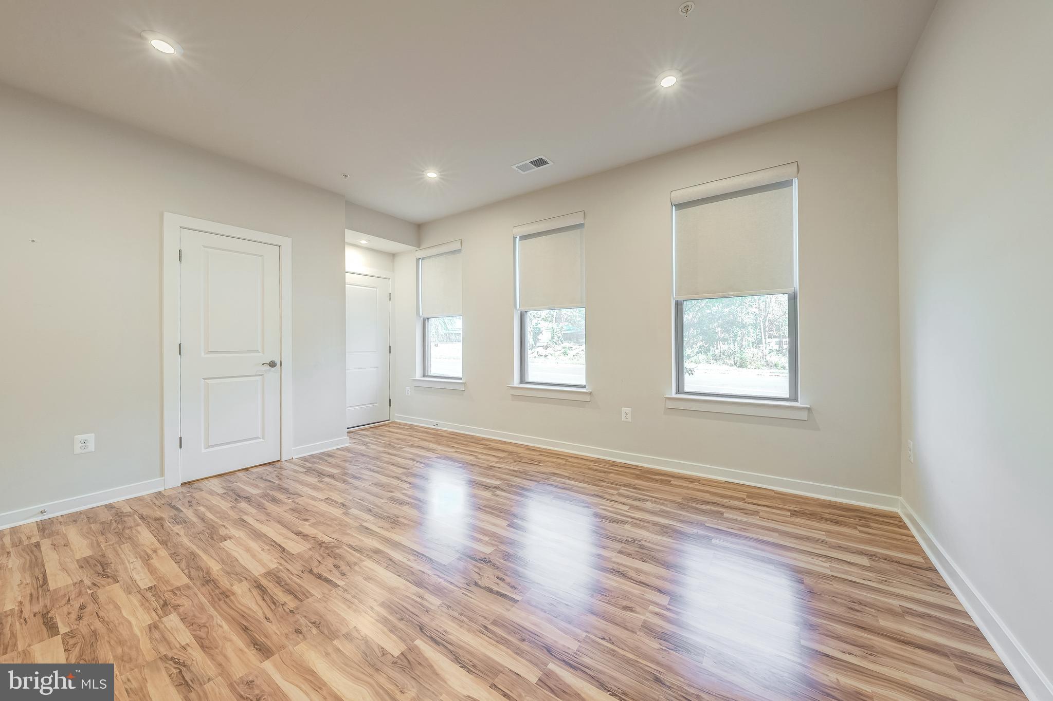 13504 Innovation Station Loop, Unit 2A Herndon, VA 20171 - Photo 9 of 36 a view of empty room with wooden floor and fan