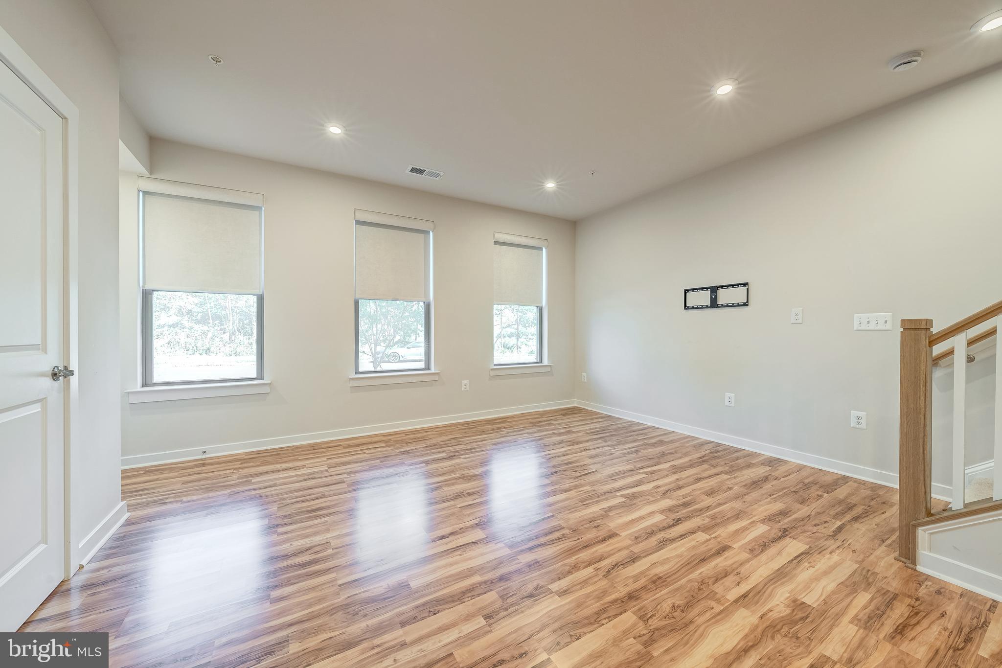13504 Innovation Station Loop, Unit 2A Herndon, VA 20171 - Photo 10 of 36 a view of empty room with wooden floor and fan