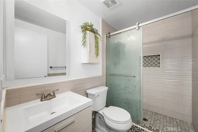 a kitchen with stainless steel appliances granite countertop a refrigerator stove and sink