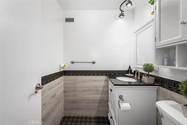 a bathroom with a shower a toilet and a sink