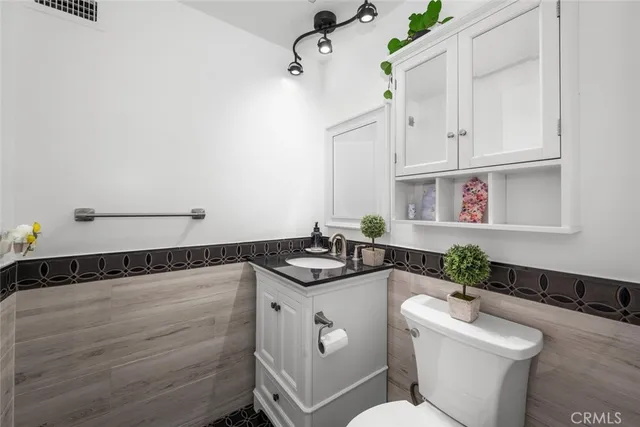 a bathroom with a granite countertop sink and a mirror