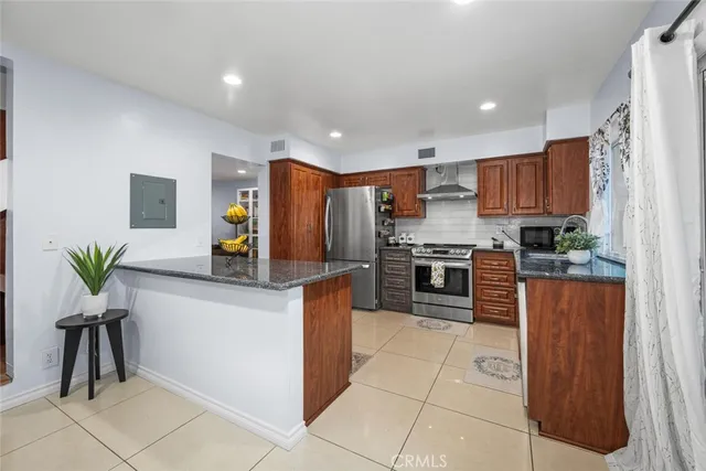 a bathroom with a granite countertop toilet sink and mirror