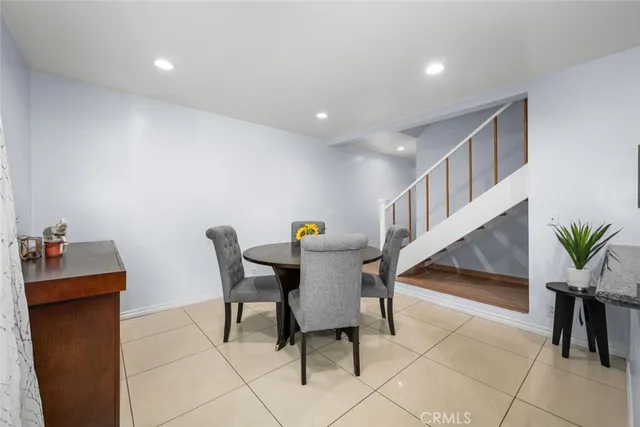 a kitchen with stainless steel appliances kitchen island granite countertop a refrigerator and a sink