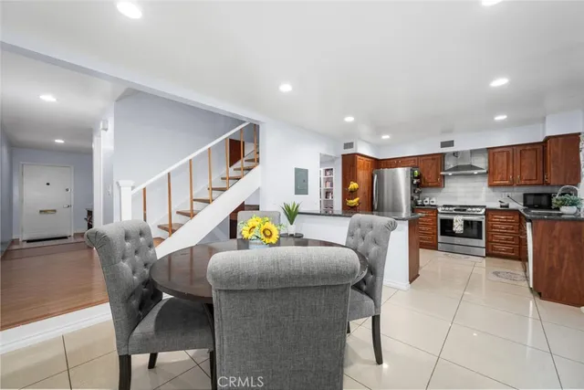 a dining room with furniture and a potted plant
