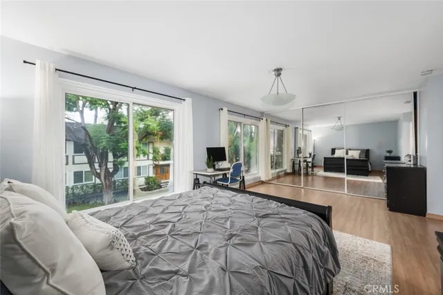 a bedroom with furniture and wooden floor