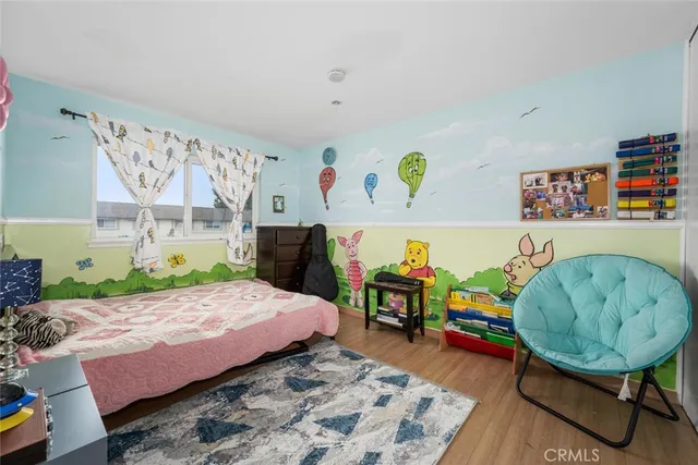 a bedroom with a bed table and a window