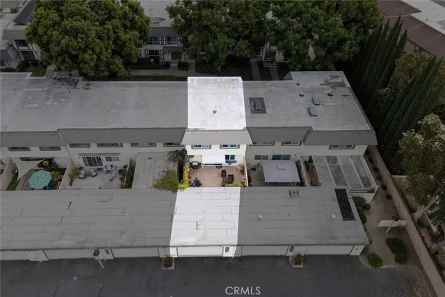 a front view of a house with plants