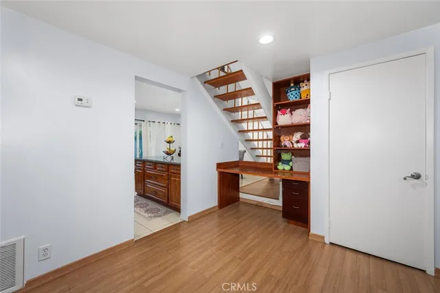 a view of wooden floor and windows in a room