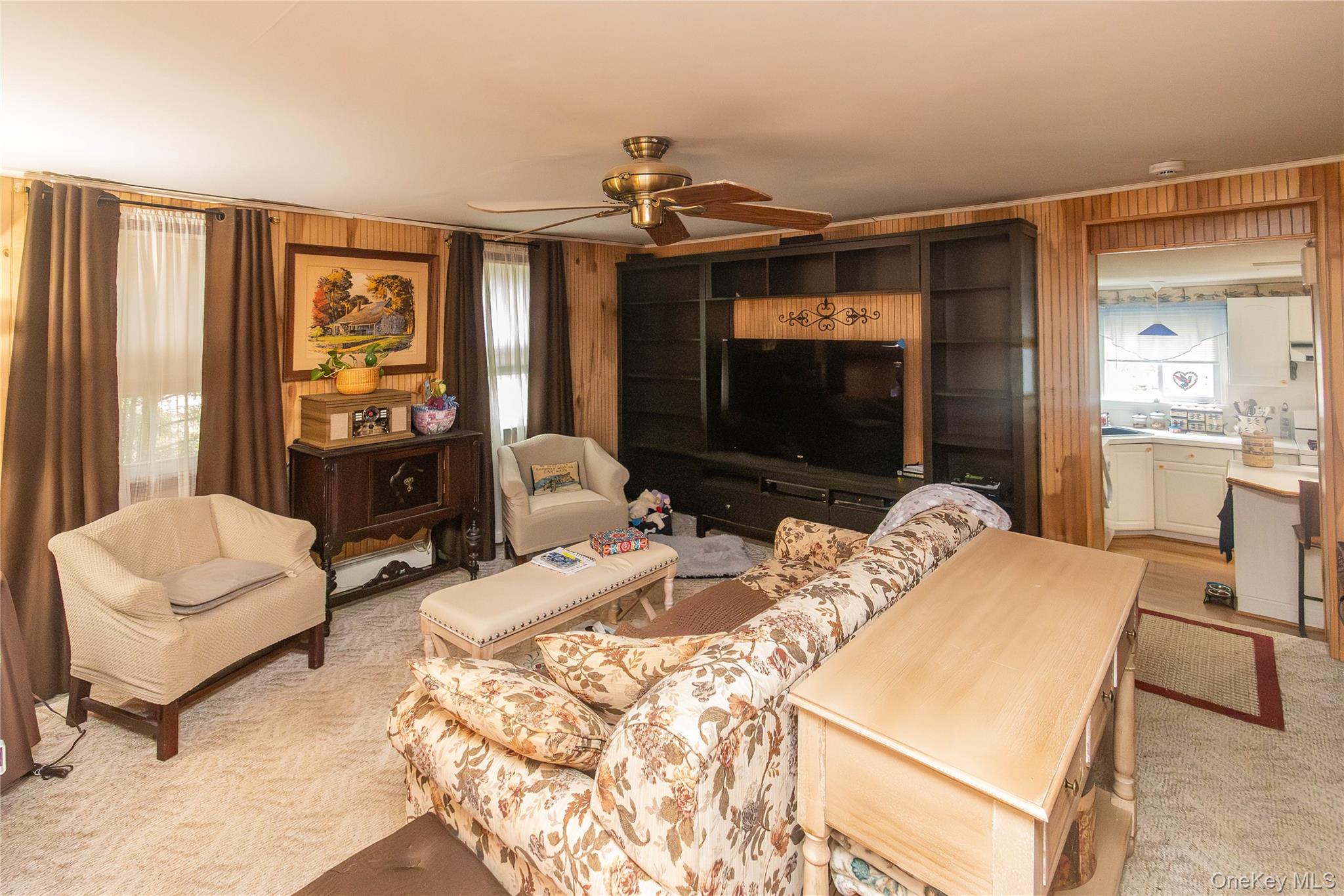 62 Thornton Road Wurtsboro, NY 12790 - Photo 10 of 30 a living room with furniture a flat screen tv and large window