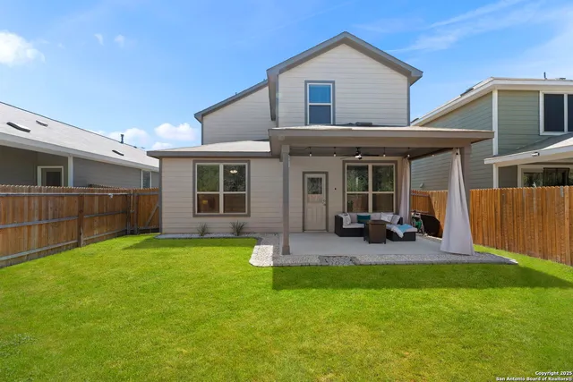 a view of a house with backyard and porch