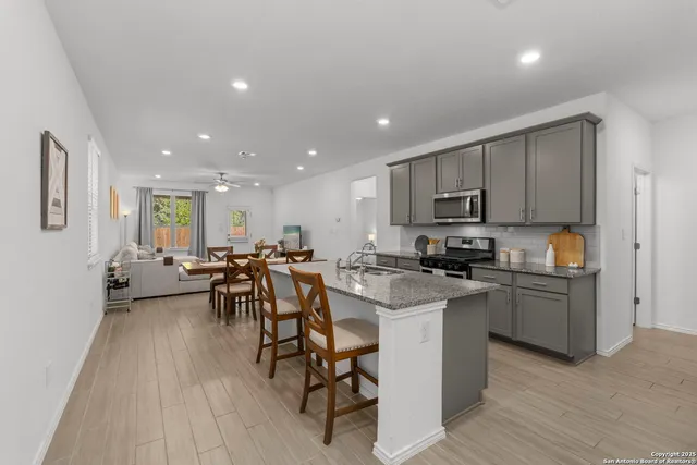 a kitchen with a sink a counter top space and stainless steel appliances