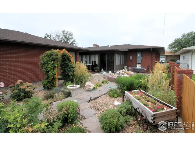 a backyard of a house with table and chairs