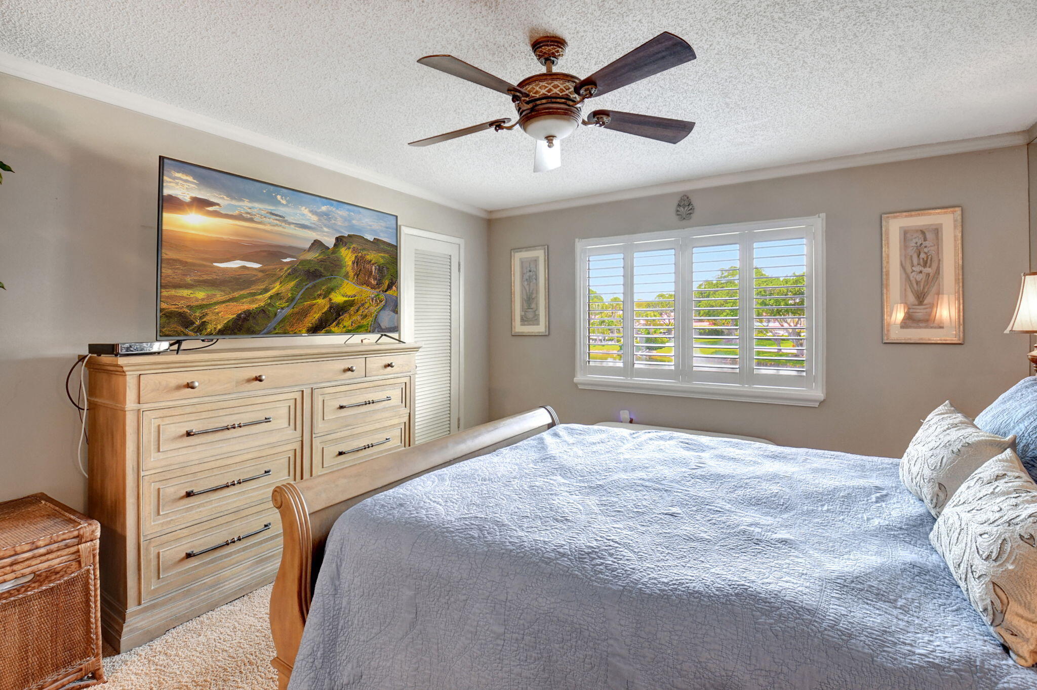 21214 Lago Circle, Unit B Boca Raton, FL 33433 - Photo 27 of 48 a bedroom with a bed and a flat screen tv