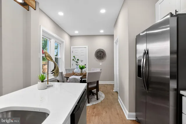 a kitchen with a refrigerator and a table